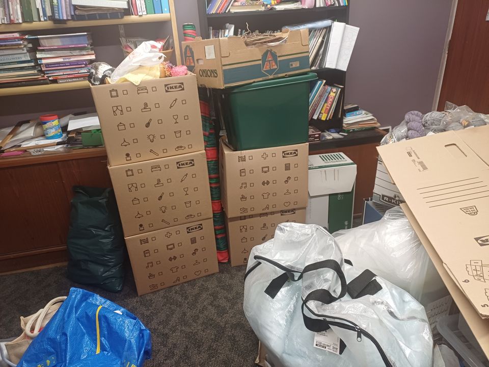Stacked flat-pack boxes, crates and big bags packed and piled ready for removal