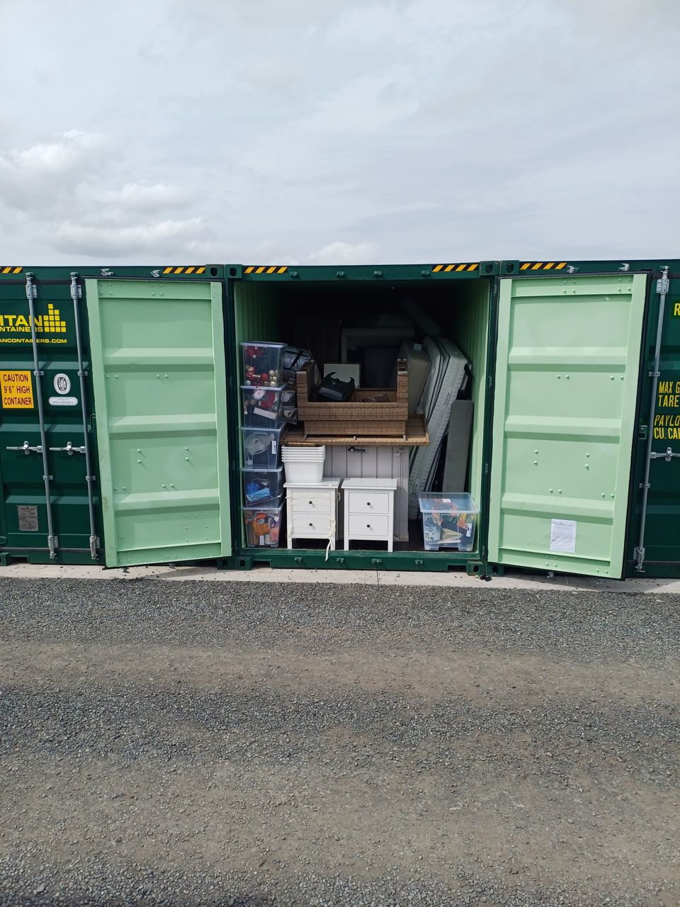 Shipping containers used for storage, doors open before clearance