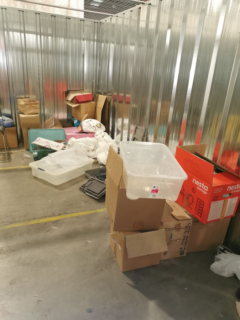 Boxes and belongings inside a storage unit before clearance