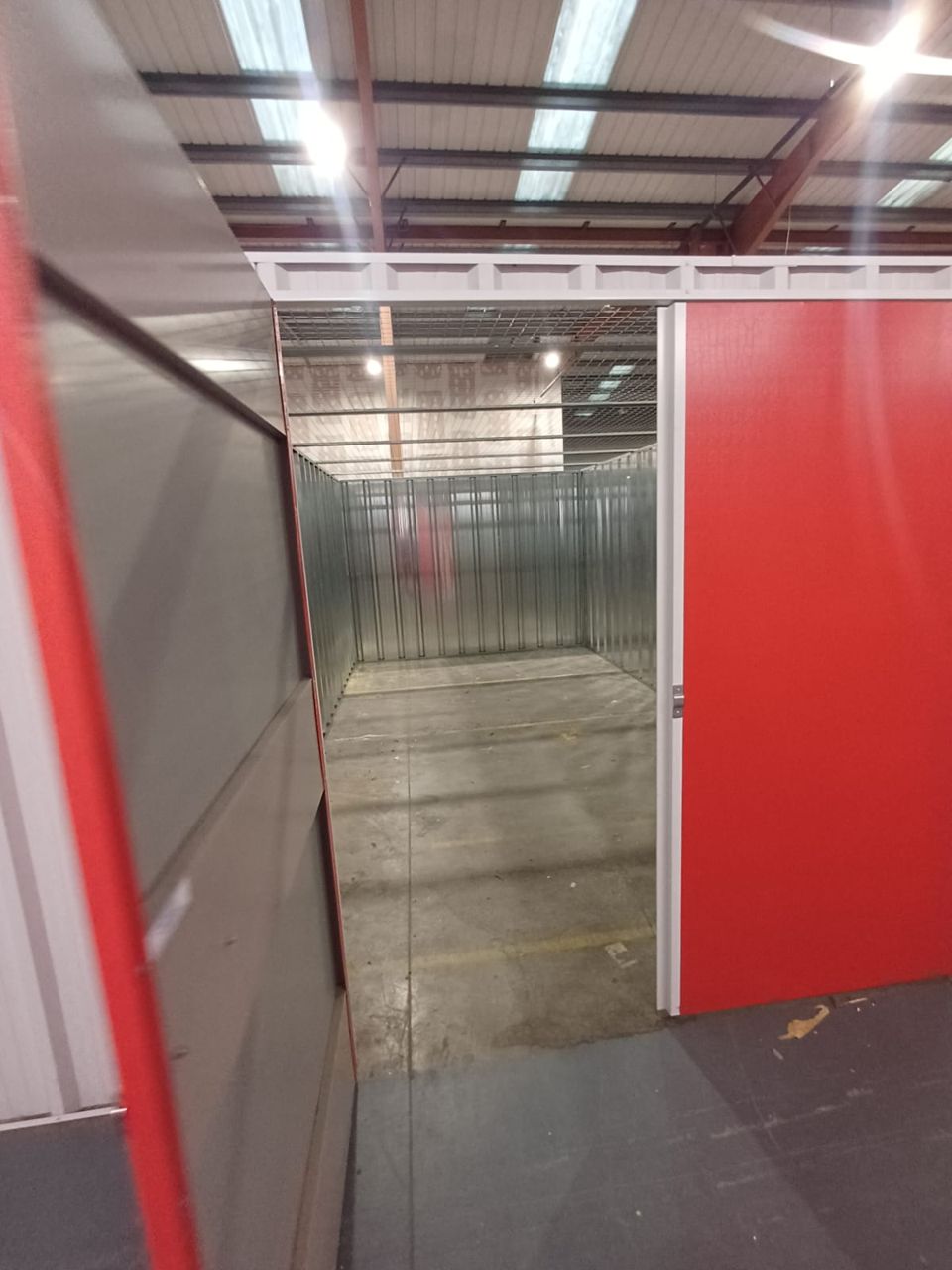 Corridor of red storage unit doors