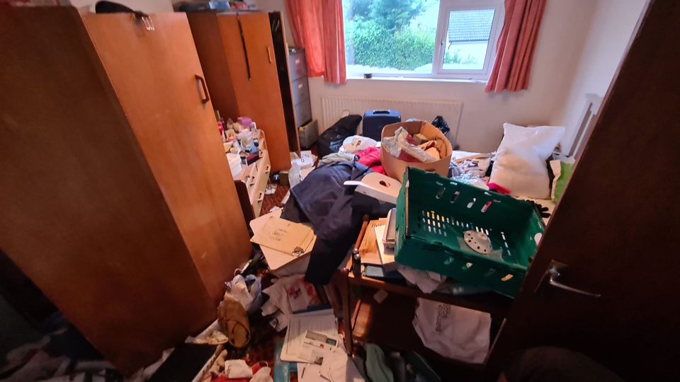 Bedroom with wardrobe, crates and clothes before clearance, Sutton