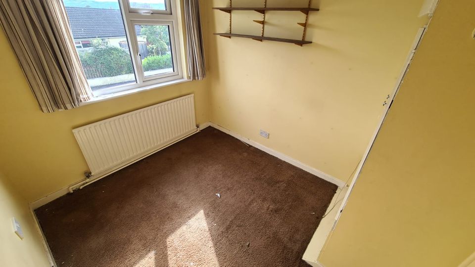 The same yellow bedroom empty after clearance, Sutton