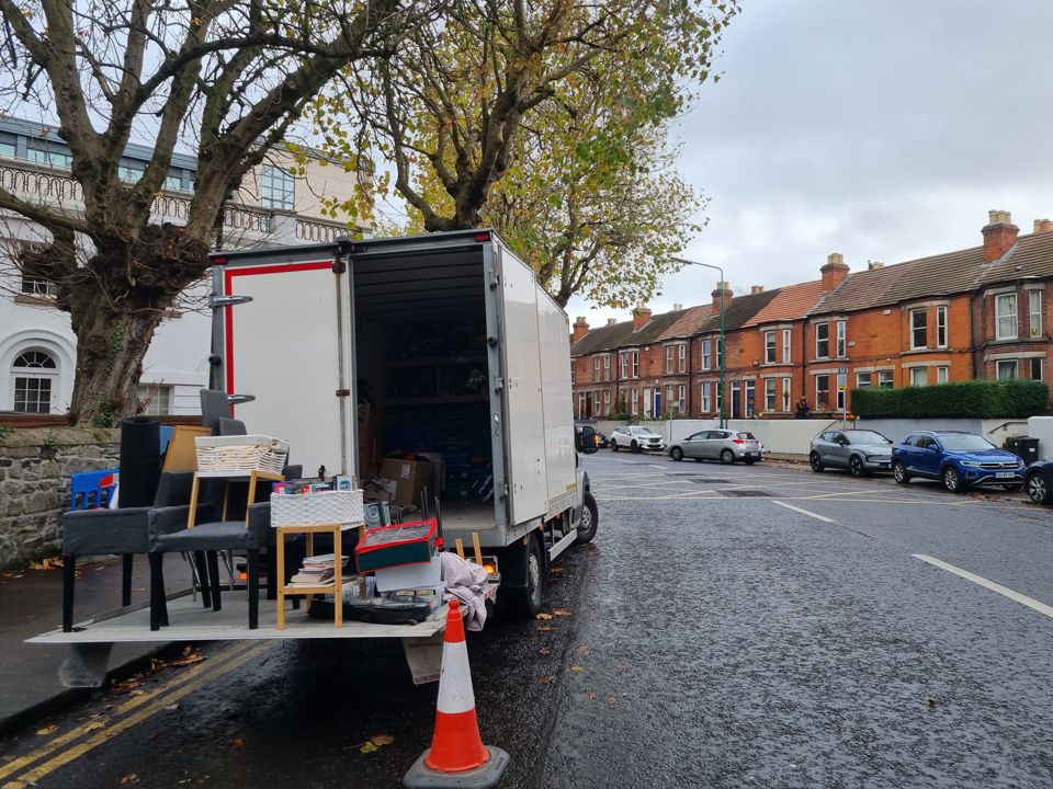 The van tail-lift down with furniture on a redbrick Dublin street